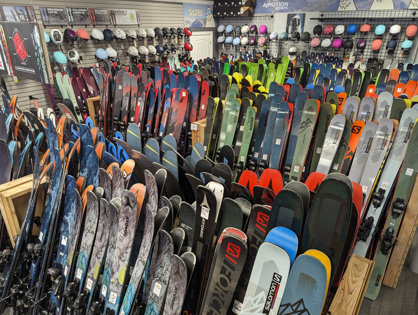 Racks of used demo skis at AJ Motion Sports - Union Square. There are hundreds of skis from Atomic, Elan, Fischer, Nordica, Salomon, & more.