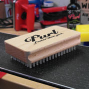 Purl nylon wax brush sitting on-top of the base of a freshly waxed ski.