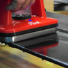 Applying Purl Ski Wax with red Purl waxing iron on a ski base for optimal glide and performance