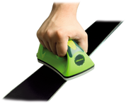 A product image showing a hand holding the Wintersteiger Wax Iron for Ski & Snowboard Waxing, the hand is guiding the wax iron across the base of a ski.