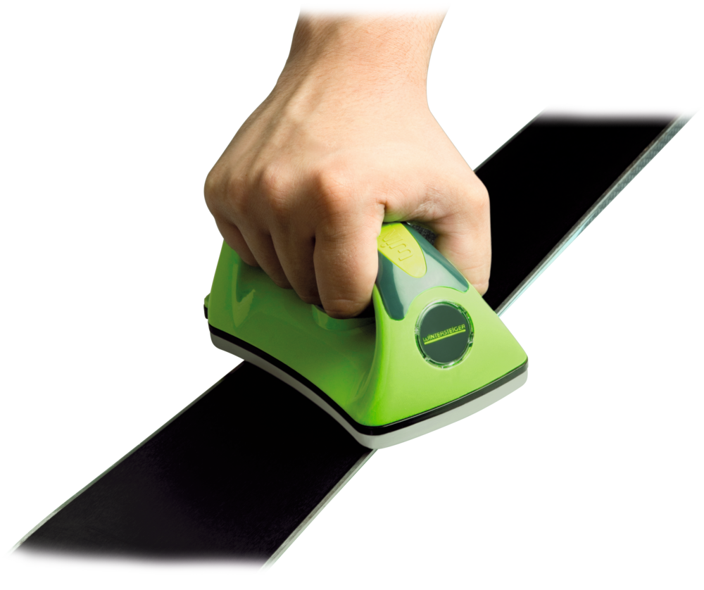 A product image showing a hand holding the Wintersteiger Wax Iron for Ski & Snowboard Waxing, the hand is guiding the wax iron across the base of a ski.
